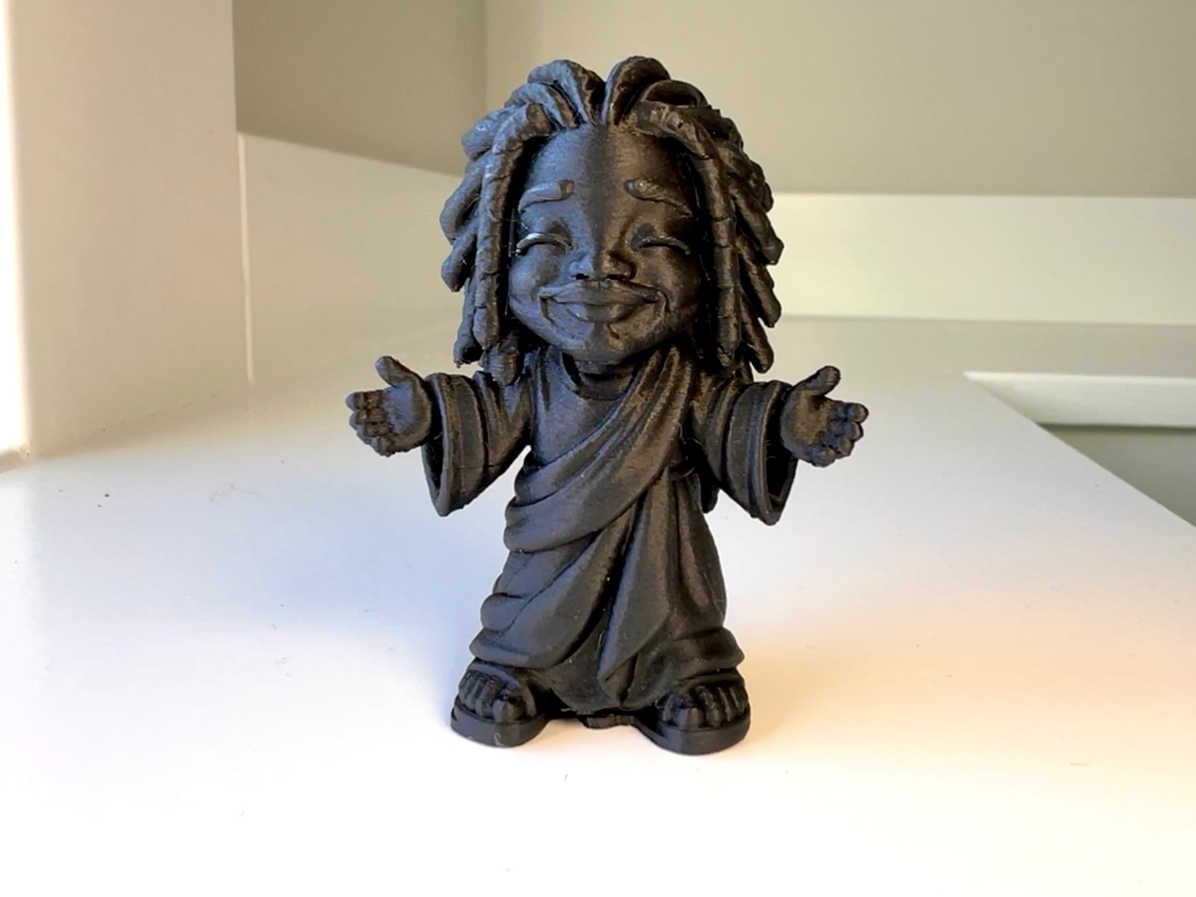 Tiny Black Jesus — clean product photograph of the 3D-printed sculpture